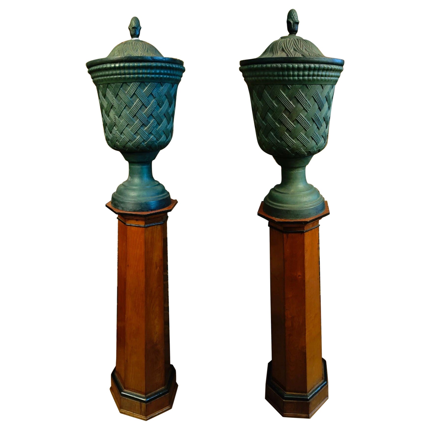  Pair of cast iron vases with lids and wooden columns