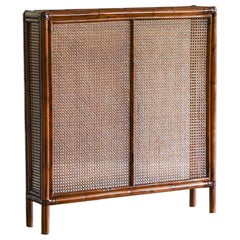 Radiator cover in bamboo and Vienna straw with leather bindings. Molto Editions