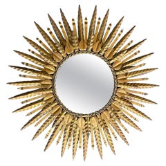 A Spanish 1950s gilt metal two tiered circular sunburst mirror