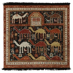 Rug & Kilim’s Tribal style rug in Black with Red, Gold-Brown Pictorial patterns