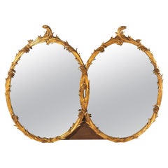 Grand miroir rococo français double ovale en bois doré à volutes et à feuilles, 20ème siècle