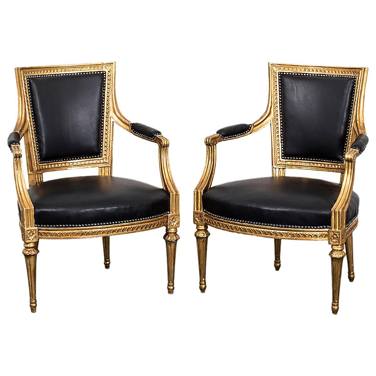 Armchairs Pair Swedish Gilt Wood Black Leather Gustavian Sweden. A pair of exquisite example of armchairs made in Sweden during the Gustavian period 1775-1810. Frame in original gilded wood with leather upholstered armrests, seat and back.