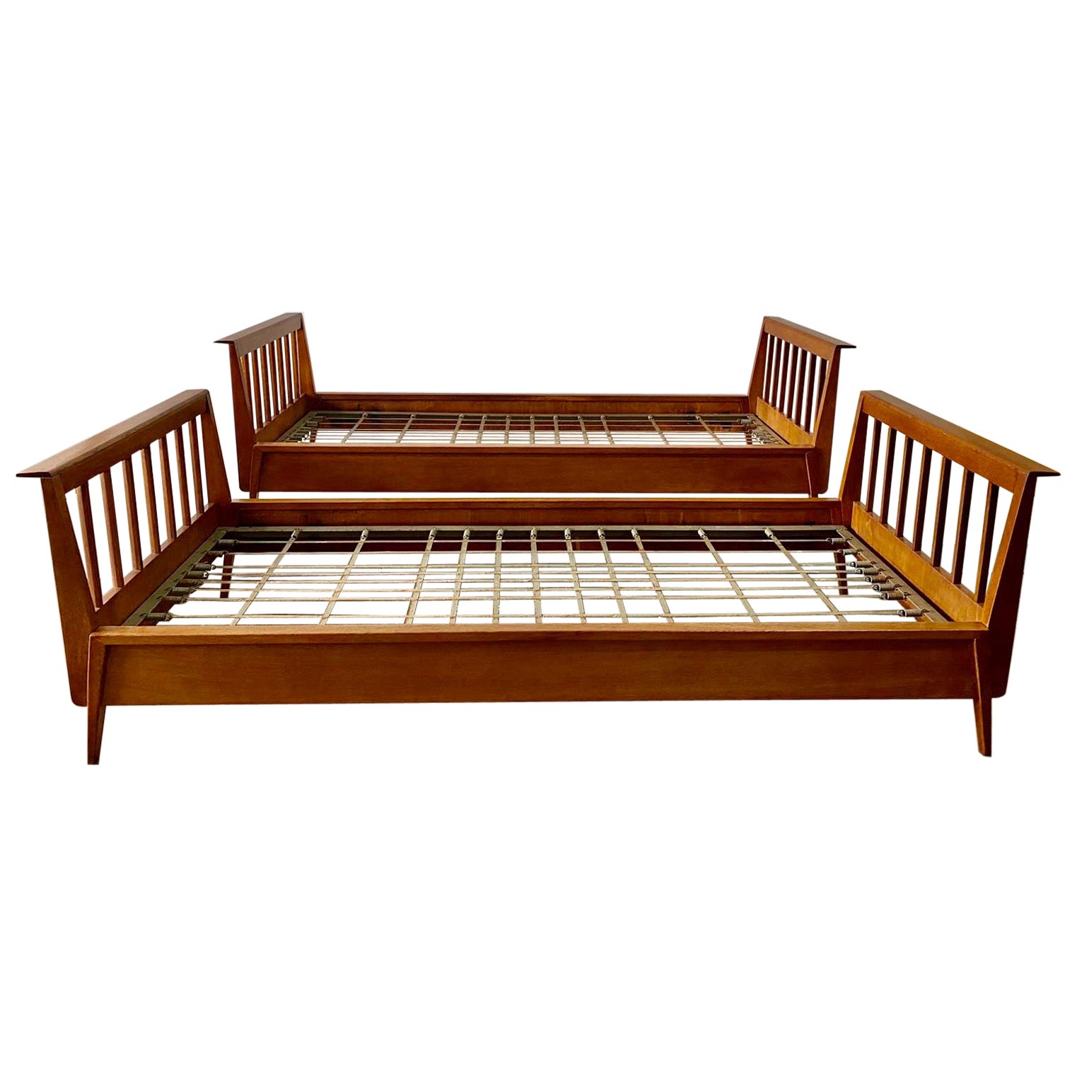 An outstanding and RARE to find PAIR of original René Gabriel daybeds/ twin beds from the reconstruction period in exquisite original patina to wood.  Flared tops on both ends, clean lines and flat spindle bar ends.  The metal frame base is original