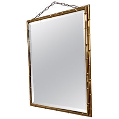 Retro 1970s wall mirror with a bamboo-effect gilded metal frame. 