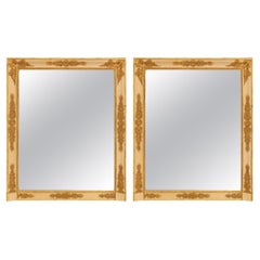 A pair of French early 19th century Empire period giltwood mirrors