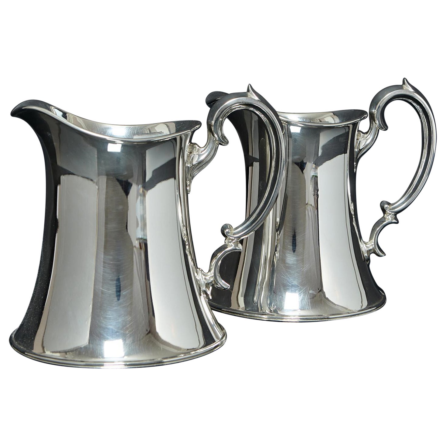 Pair of Arts & Crafts silver water jugs
