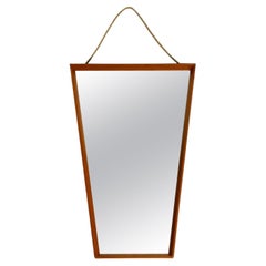 Large 1950s wall mirror in trapezoidal shape with a solid cherry wood frame