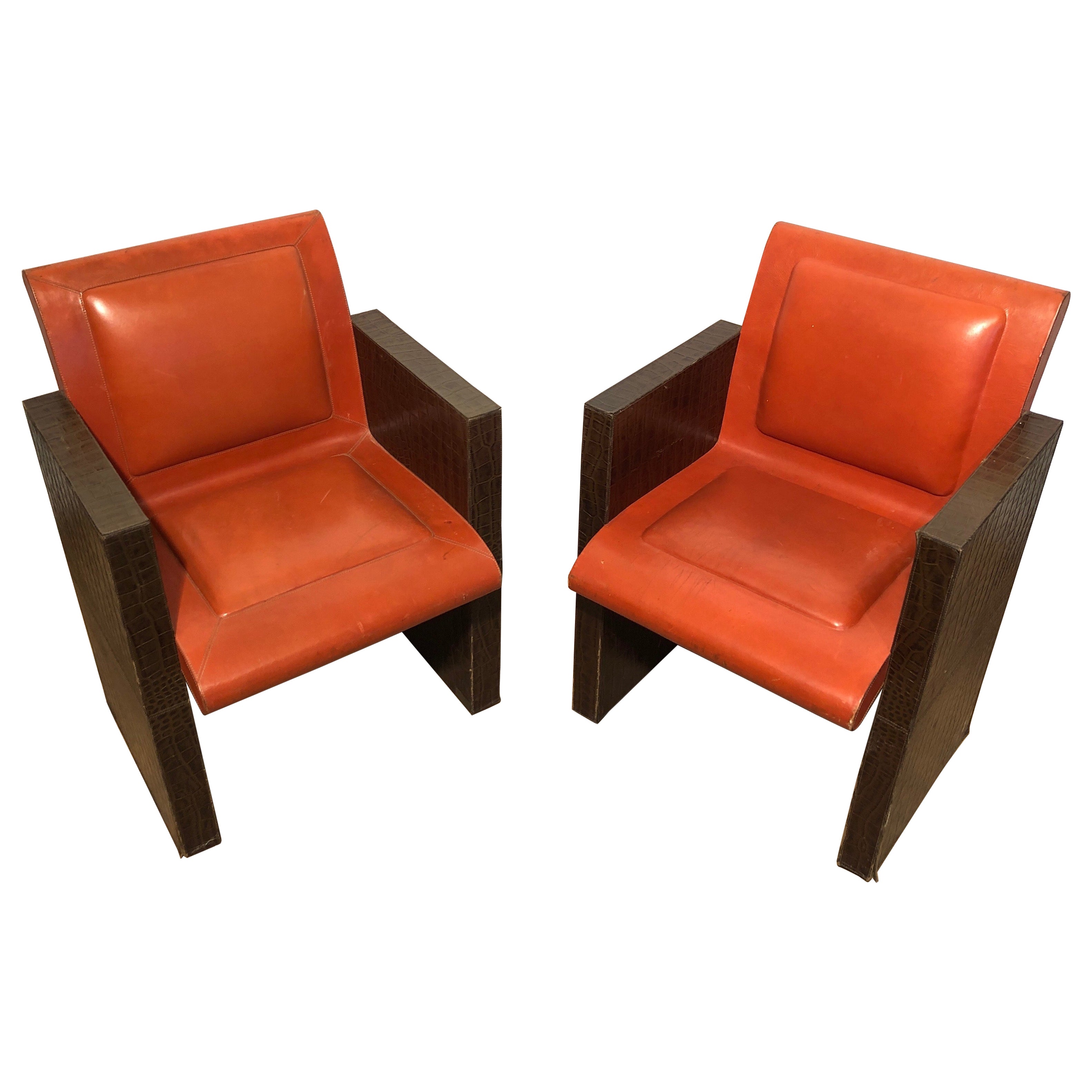 Pair of orangeish and brown leather armchairs (Can be sold individually).  For Sale