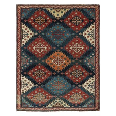 Alfombra antigua caucásica kazaka con motivos tribales rojos y azules de Rug & Kilim
