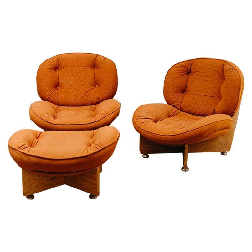a pair of 1970's lounge chairs and one ottoman/pouf