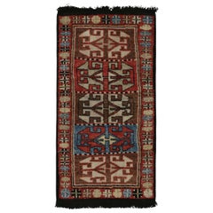 Rug & Kilim’s Tribal style rug in Red, Brown and Blue geometric pattern