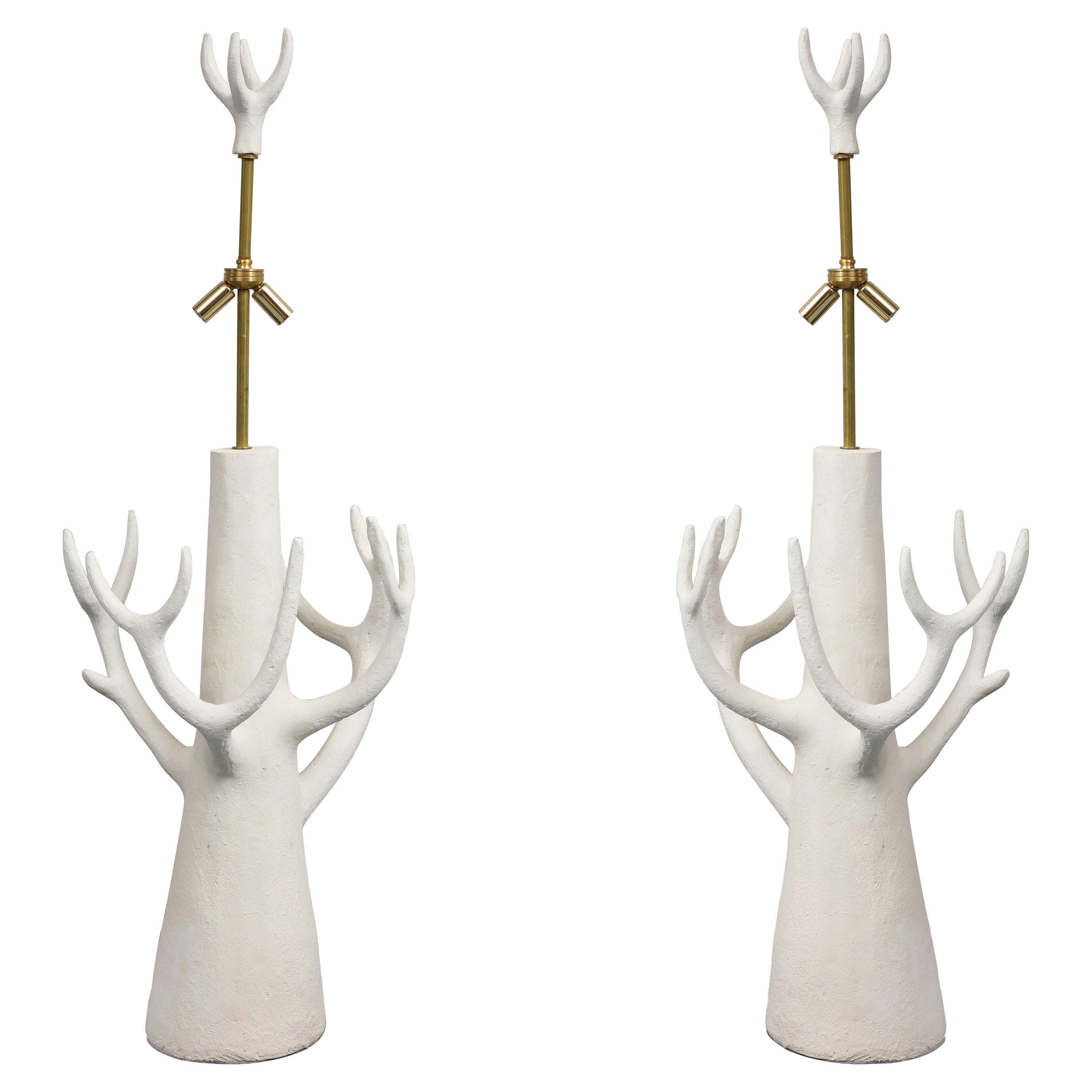 This pair of lamps in white ceramic was created by the sculptor Jacques Darbaud.  Tree was probably the inspiration. The lamps  are American wired. These lamps  can be considered as well as sculptures. 