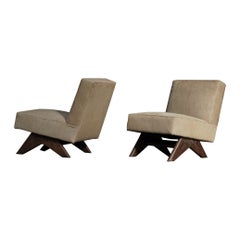 Pair of Pierre Jeanneret Fireside chairs in Ecru Cowhide