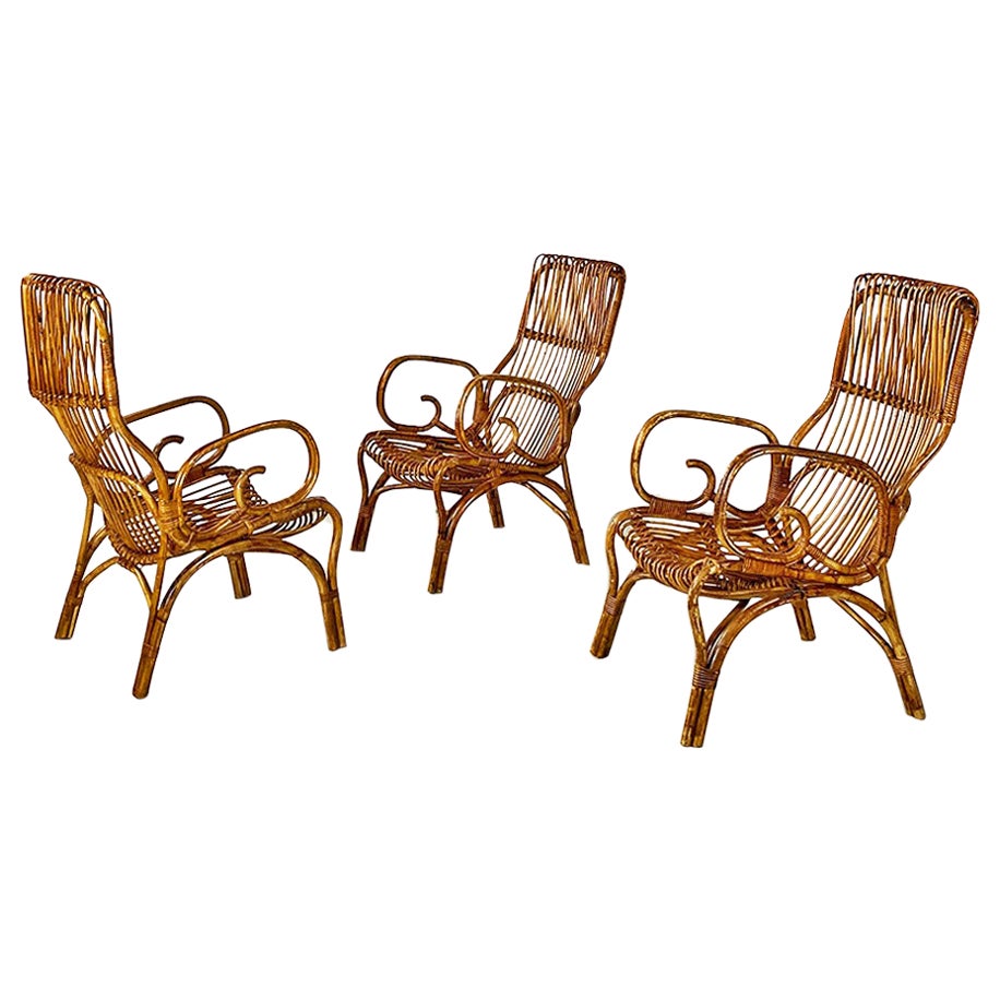 Italian mid century modern set of three curved lines rattan armchairs, 1960s For Sale