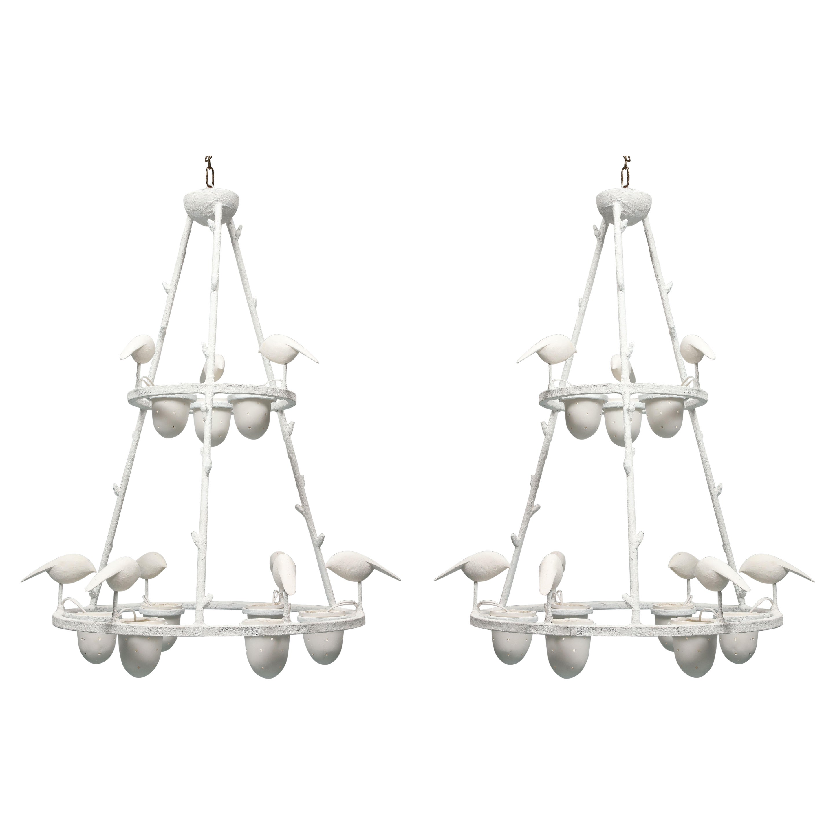 This pair of chandeliers is impressive by its scale.It has been created by the sculptor Jacques Darbaud. The structure which  is in metal is covered by white plaster . It has 9 lights, American wired. The design shows birds perching on the frame and