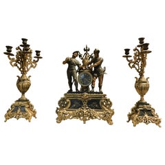 fireplace triptych in bronze formed by clock and 2 candlesticks, Italy