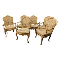 N.6 armchairs in gilded and carved wood, fabric with floral decorations, Italy