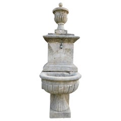 Antique Fountain in gray stone, with spout and applied to the wall, Italy