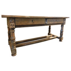 Solid walnut table, richly carved with two drawers, Italy