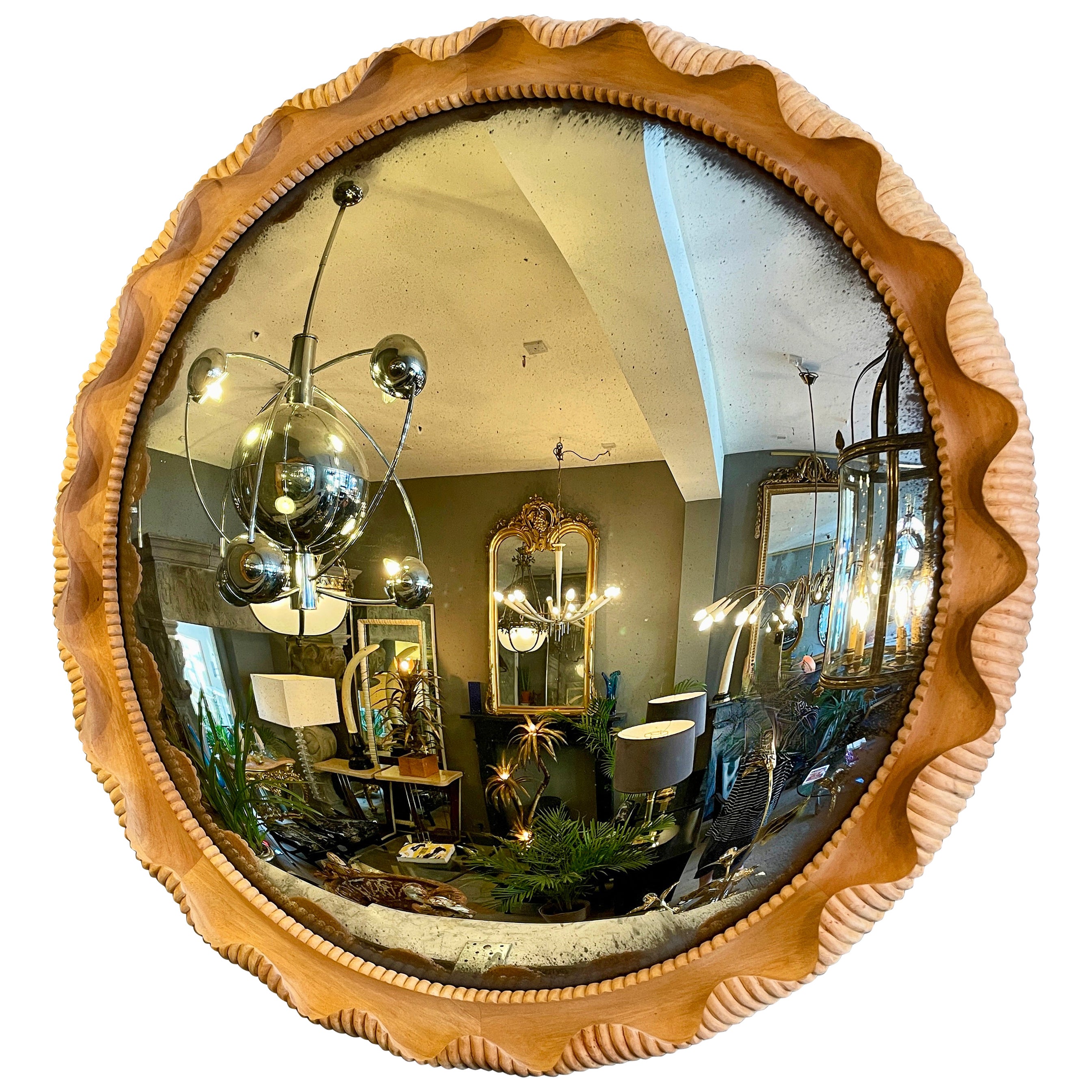 A large Distressed Convex Mirror Within a Carved Oak Frame  For Sale