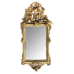 Ornately Carved French Rococo Gilt-wood Mirror with Exuberant Crest