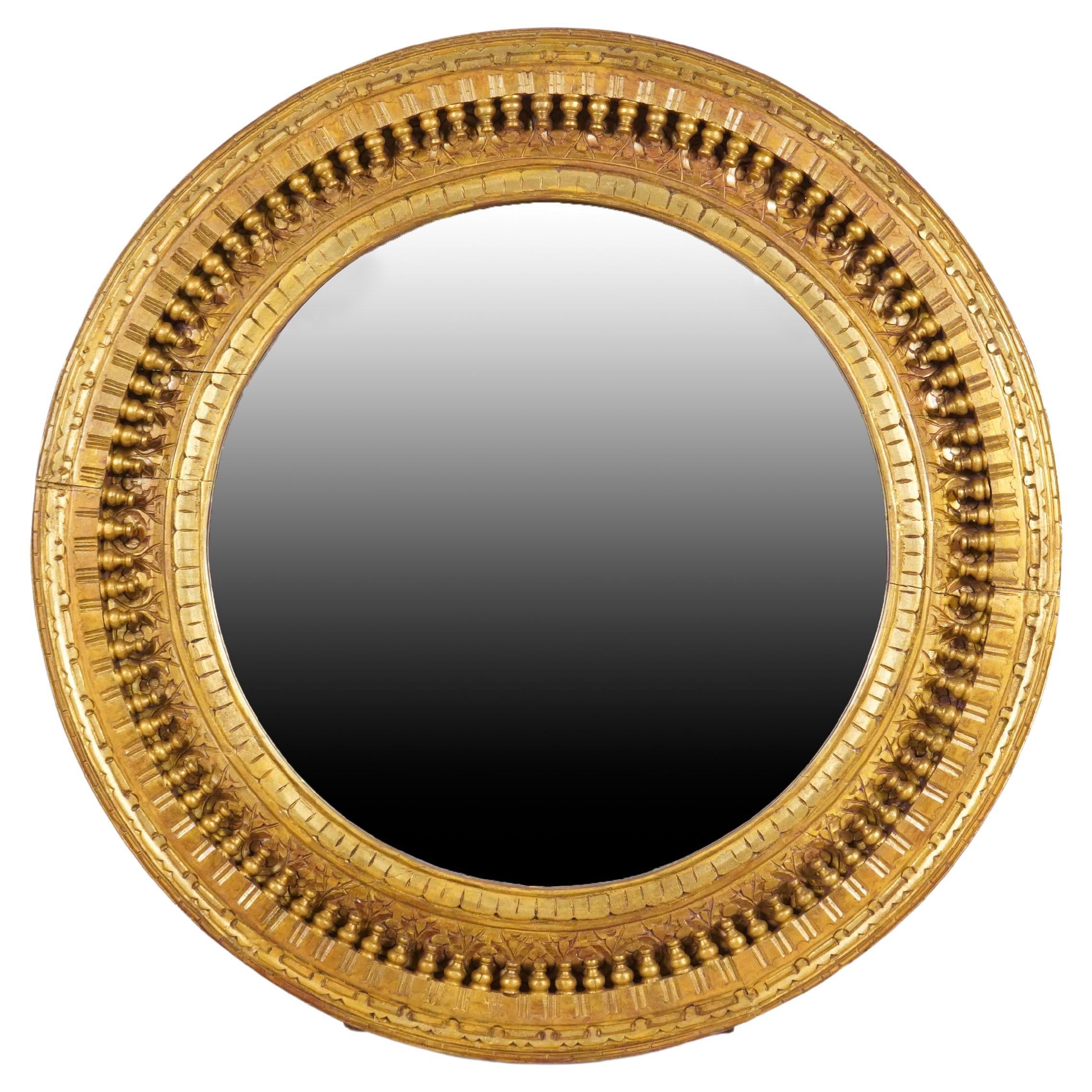 A Carved Mango Wood Round Mirror Frame