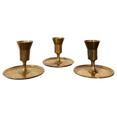 Set of three Pierre Forssell candle sticks in brass