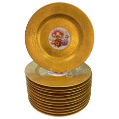 An opulent set of 12 gold encrusted floral service plates