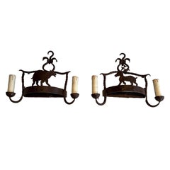 Pair of wrought iron wall lights showing animals. French work. Circa 1950