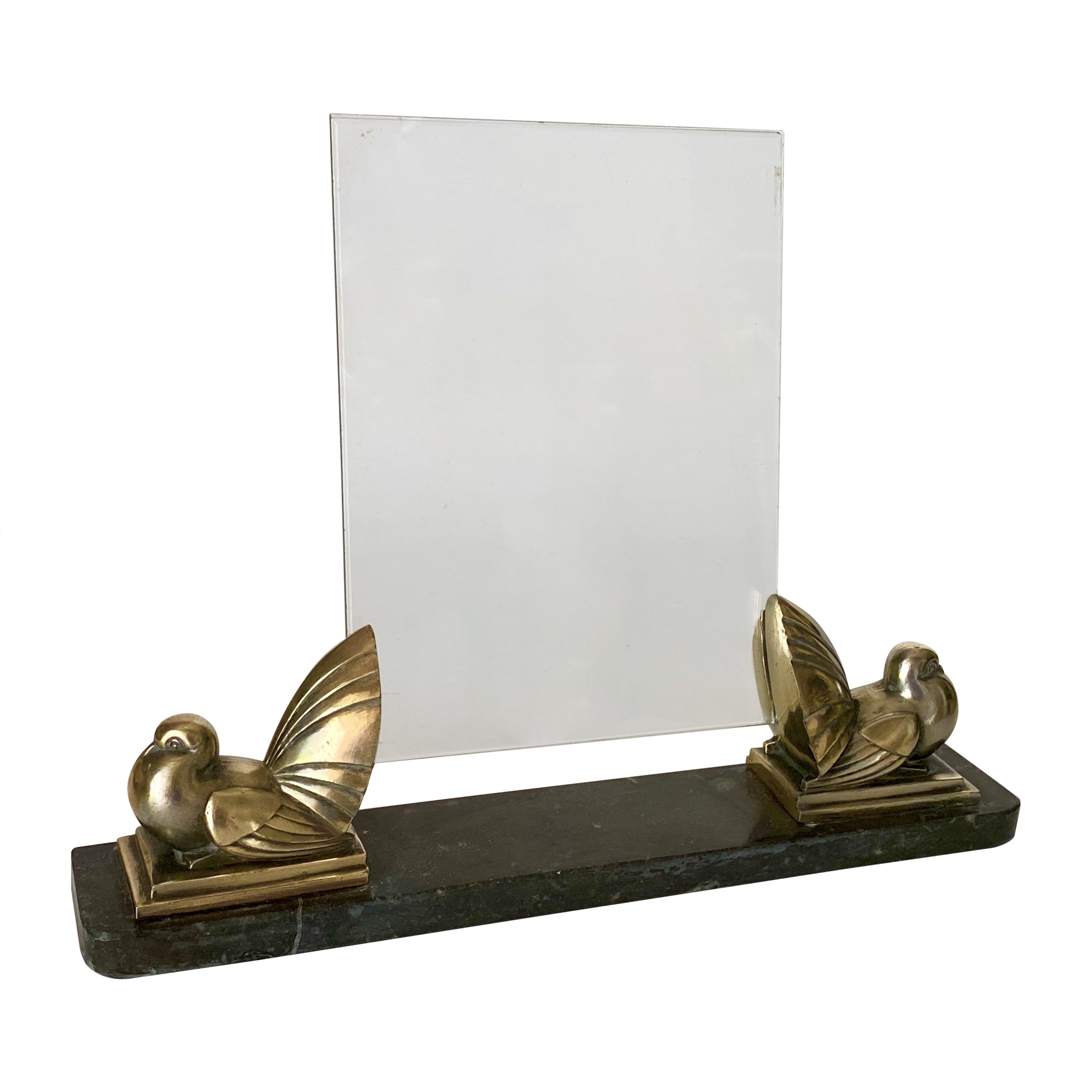 This whimsical and sophisticated picture Art Deco Machine Age frame was realized in France, circa 1935. It features two Brass Sculptures, representing Birds, sit on a volumetric rectangular basein Marble a rectangular pair of glass sheet  intended