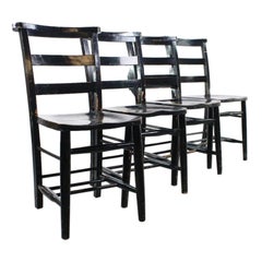 A Set of Four Early 20th Century Black Painted Chapel Chairs