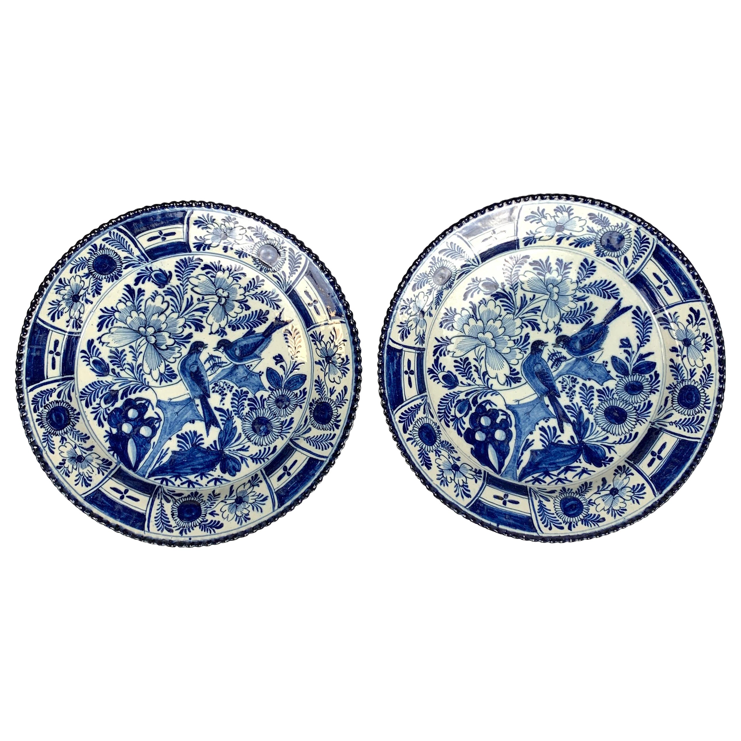 This pair of Dutch Delft blue and white chargers were hand-painted in the last quarter of the 18th century, circa 1780.
They feature beautiful long-tailed songbirds resting on a branch among flowers and rockwork.
The garden is filled with exquisite