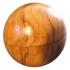 A Treen Sphere Enclosing Needle and Thread Spool   