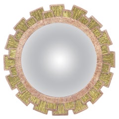 A green glass and resin concave mirror in the "Mazarin" style.