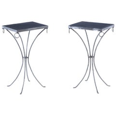 A pair of polished iron drinks tables.