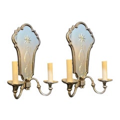 A circa 1930's silver plated sconces with etched mirrored backplate