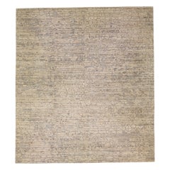 Tapis moderne en laine beige surdimensionné avec motif abstrait sur toute sa surface