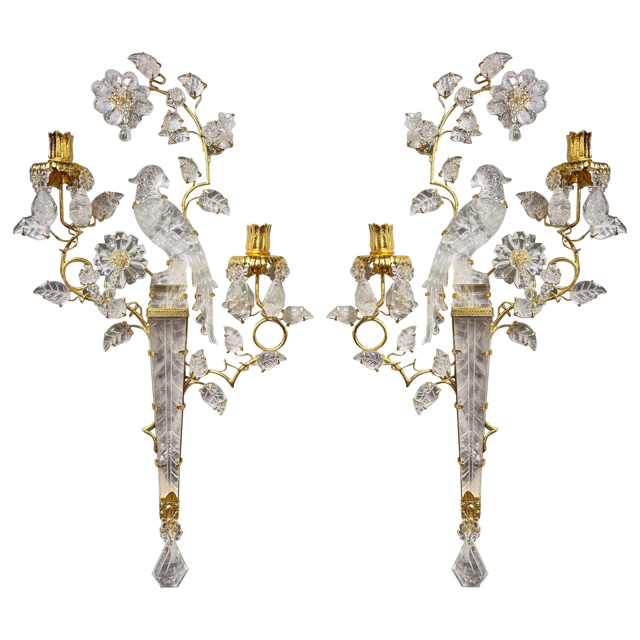 Pair of opulent Uccello sconces in cut crystal and gilt bronze. Each sconce contains two lights with gilt bronze flower sockets resting on gilt bronze branches emerging from the bird's inverted obelisk perch which has beed etched with a leaf vein