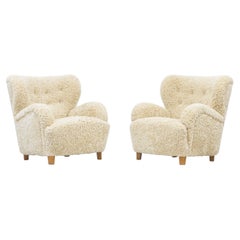 Danish modern sheepskin lounge chairs in the style of Flemming Lassen