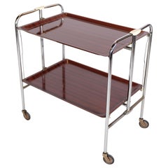 Rolling table in chrome with Imitation mahogani surface with Wheels. 