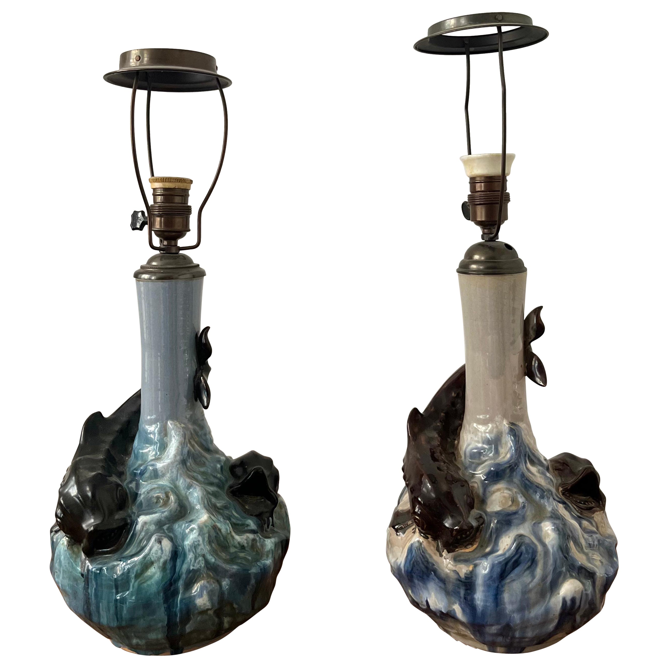 This rare pair of Danish ceramic table lamps are designed by Hans Ancher Wolffsen (1870-1929) / Søholm and is exhibited at Bornholms Museum. Highly decorated and with a glossy glaze and sculpted fish in a roaring sea, this design was made around