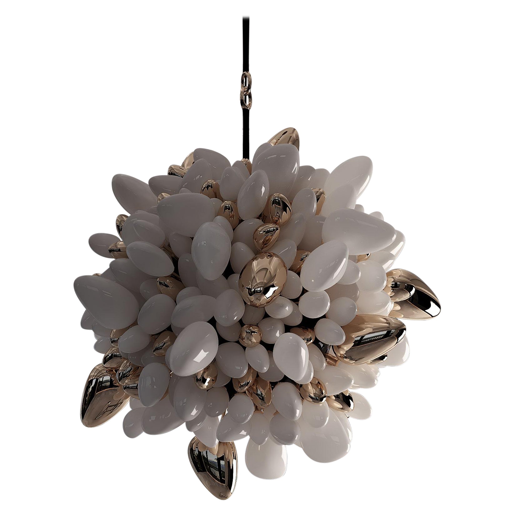 Gaia is not simply a chandelier; it is a testament to the Goddess of Natural World. This chandelier seamlessly merges different shaped, sized glass and bronze, each carefully chosen to evoke a sense of wonder and mystique. From delicate spheres to