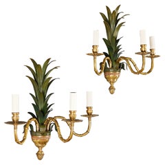 A pair of large palm frond brass wall lights 