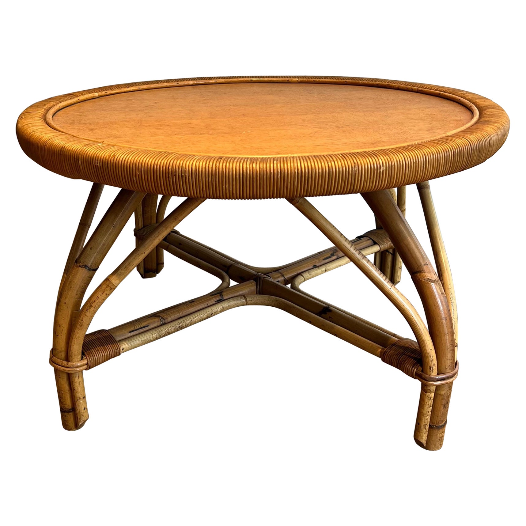 Round rattan coffee table with a wooden top attributed to Audoux
