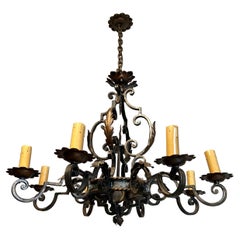 Large wrought iron chandelier with 8 arms and decorated with gilt iron palmettes