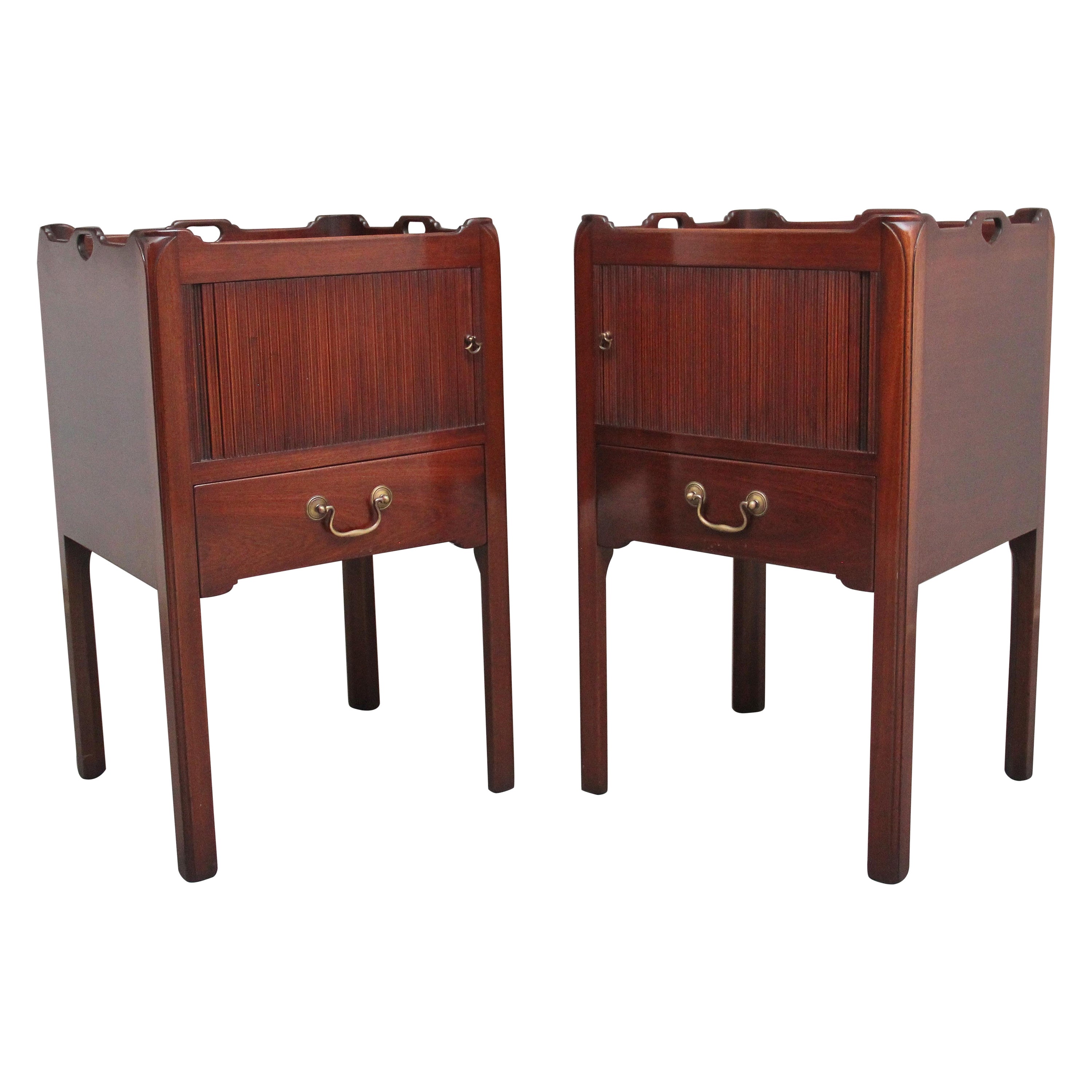 A pair of mahogany tray top bedside cabinets in the Georgian style