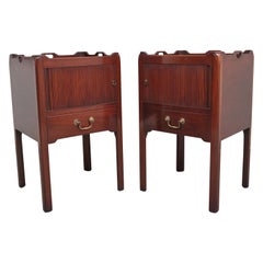 A pair of mahogany tray top bedside cabinets in the Georgian style