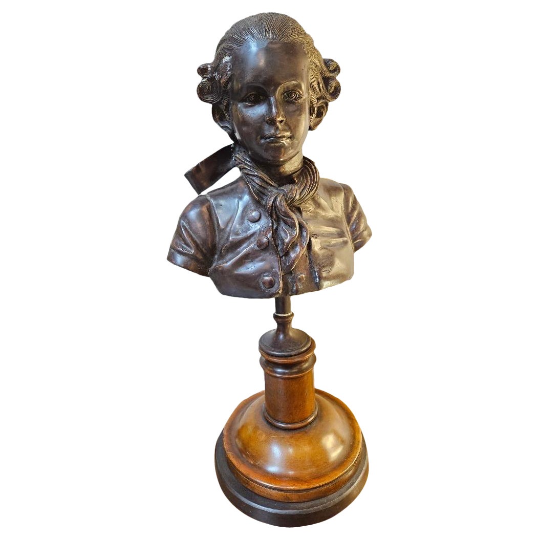 A Patinated bronze Bust of a Young Mozart on Fruitwood and Ebonized Base 