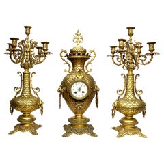 A French 19th-20th Century Gilt-Metal 3-Piece Clock and Candelabra Garniture Set