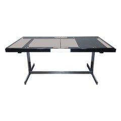 Extendable chrome dining table in the style of Milo Baughman